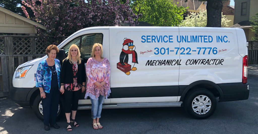 Service Unlimited van with administration staff